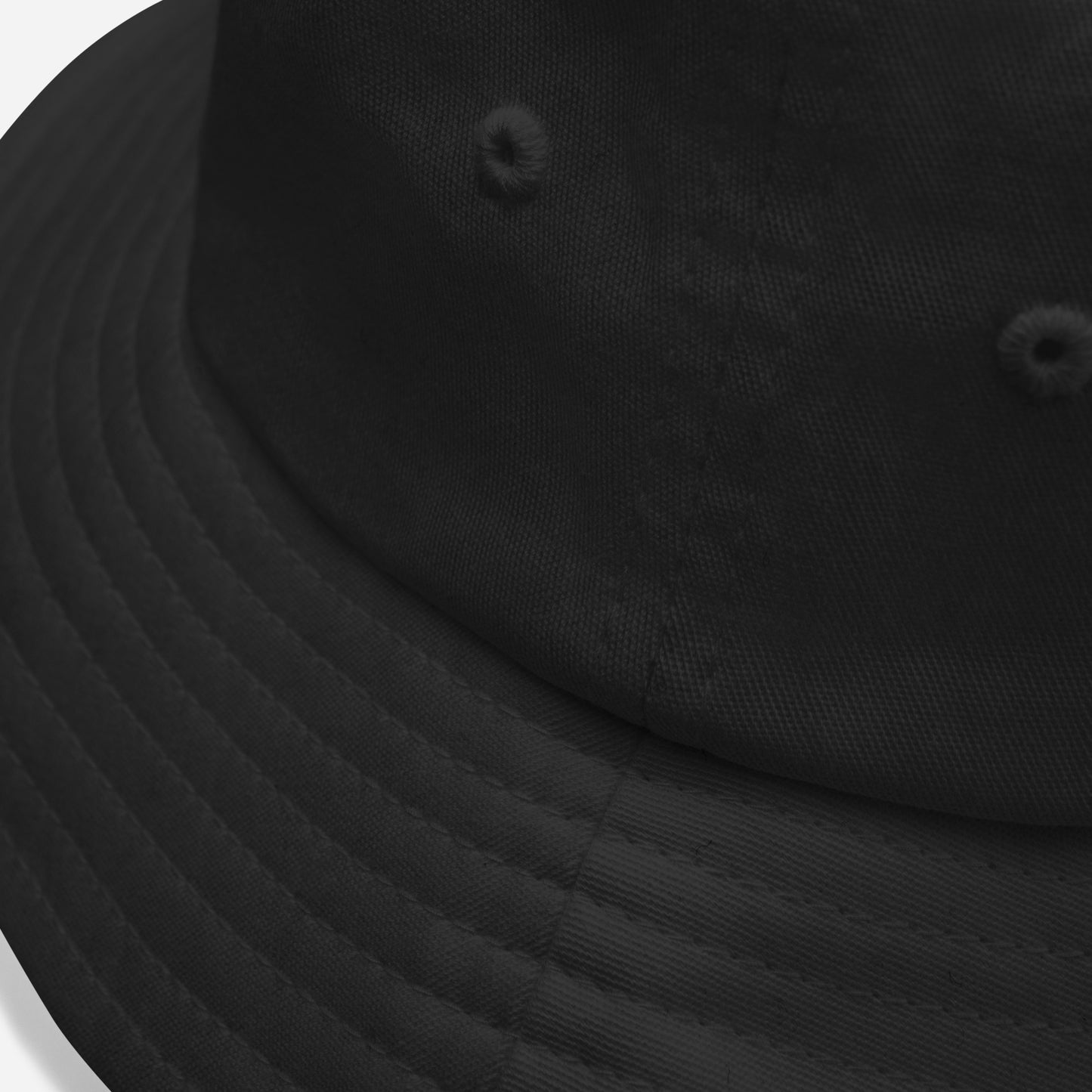 Angled top-down view of the black Creatpix bucket hat, showing the clean lines of its 3-inch crown and minimalist design