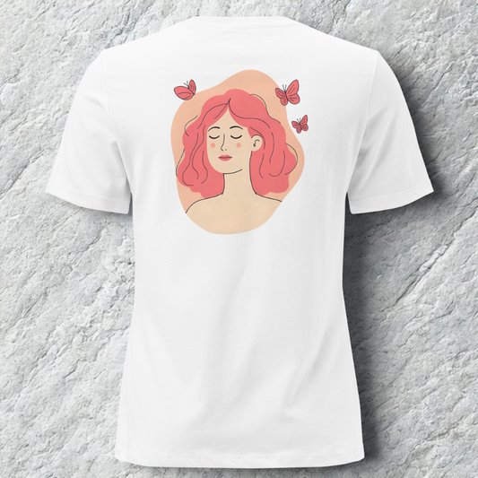 Back view of white tee with soft portrait of a woman with pink hair and small butterflies inside a peach oval, cool grey stone backdrop.