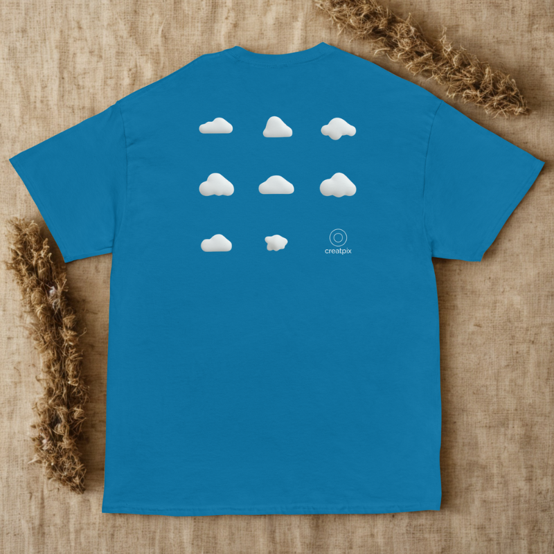 Back view of blue tee with a 3×3 grid of soft white clouds, laid on light natural surface with twigs.