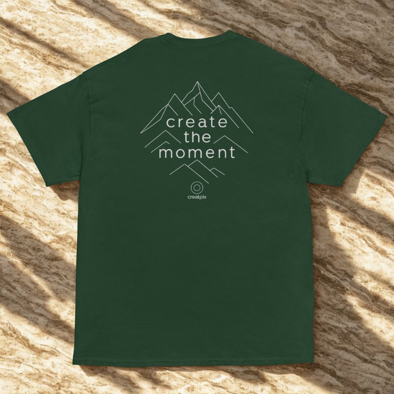 Back view of green organic cotton unisex t-shirt featuring 'create the moment' mountain peaks design in minimalist mountain graphic; sustainable and eco-friendly.