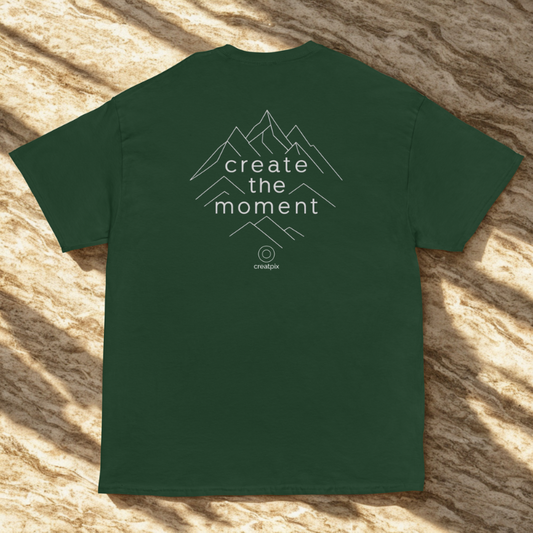 Back view of green organic cotton unisex t-shirt featuring 'create the moment' mountain peaks design in minimalist mountain graphic; sustainable and eco-friendly.