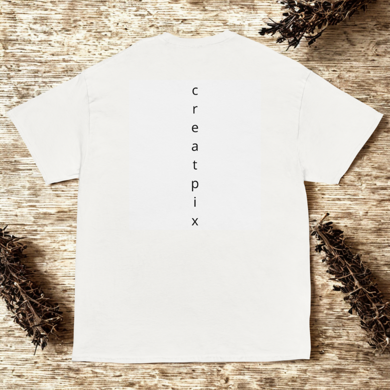 Back view of white tee with vertical “creatpix” wordmark centered, rustic wood surface with dried twigs.