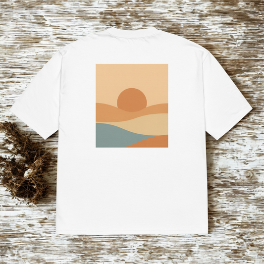 Back view of white tee with small square minimalist sunset landscape illustration, rustic wood backdrop.