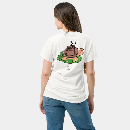 Back view of white T-shirt with cute turtle carrying a vintage camera illustration.