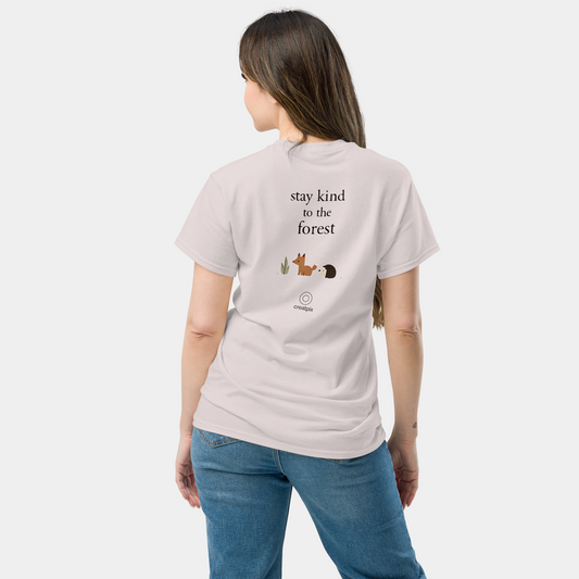 Back view of a white t-shirt with “stay kind to the forest” text above small cute woodland icons and a subtle Creatpix mark.