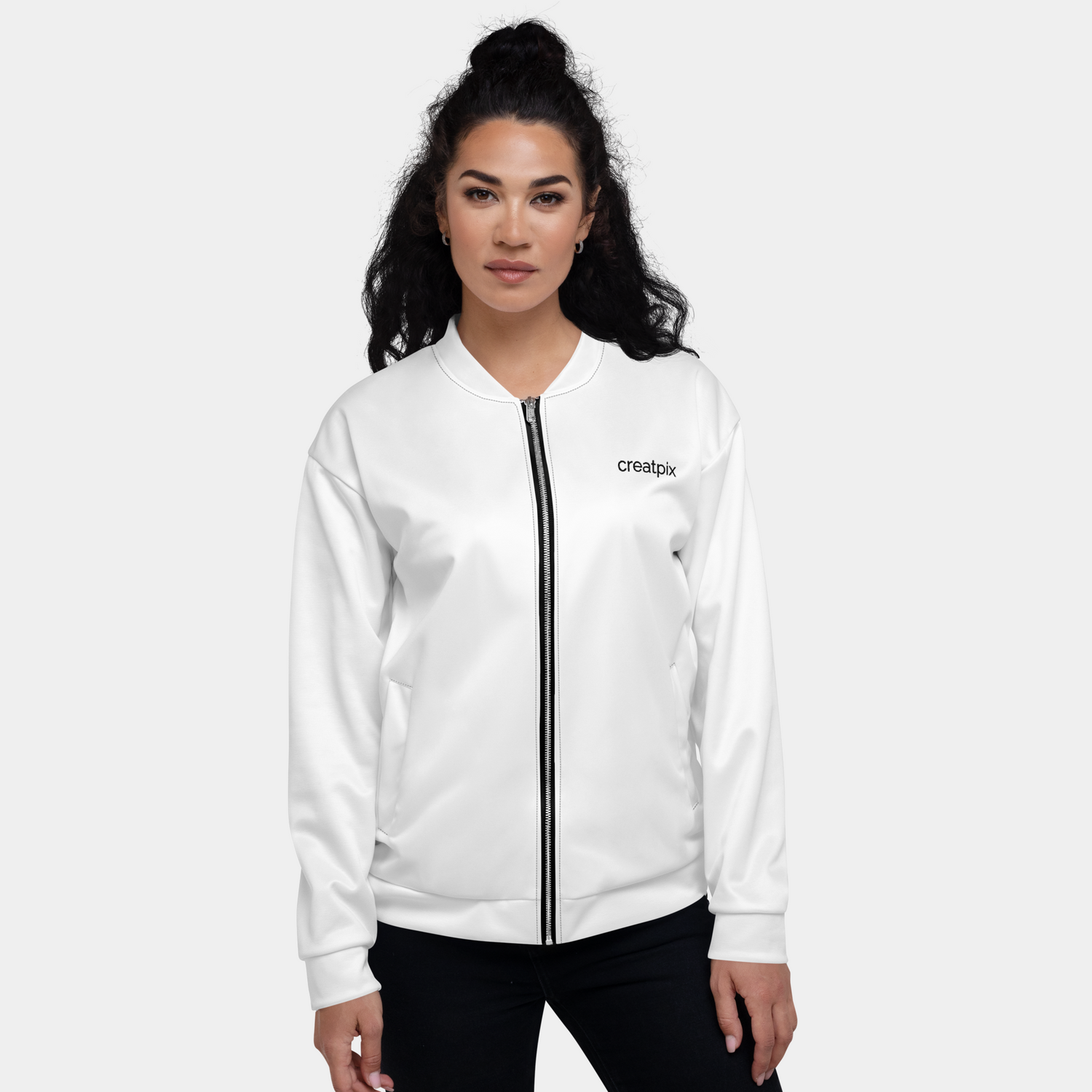 Woman wearing the white clean zip style bomber jacket with a minimalist black Creatpix logo on the chest and a silver YKK zipper