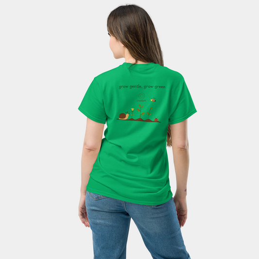Back view of green Creatpix t-shirt with garden scene and the quote “grow gentle, grow green.”