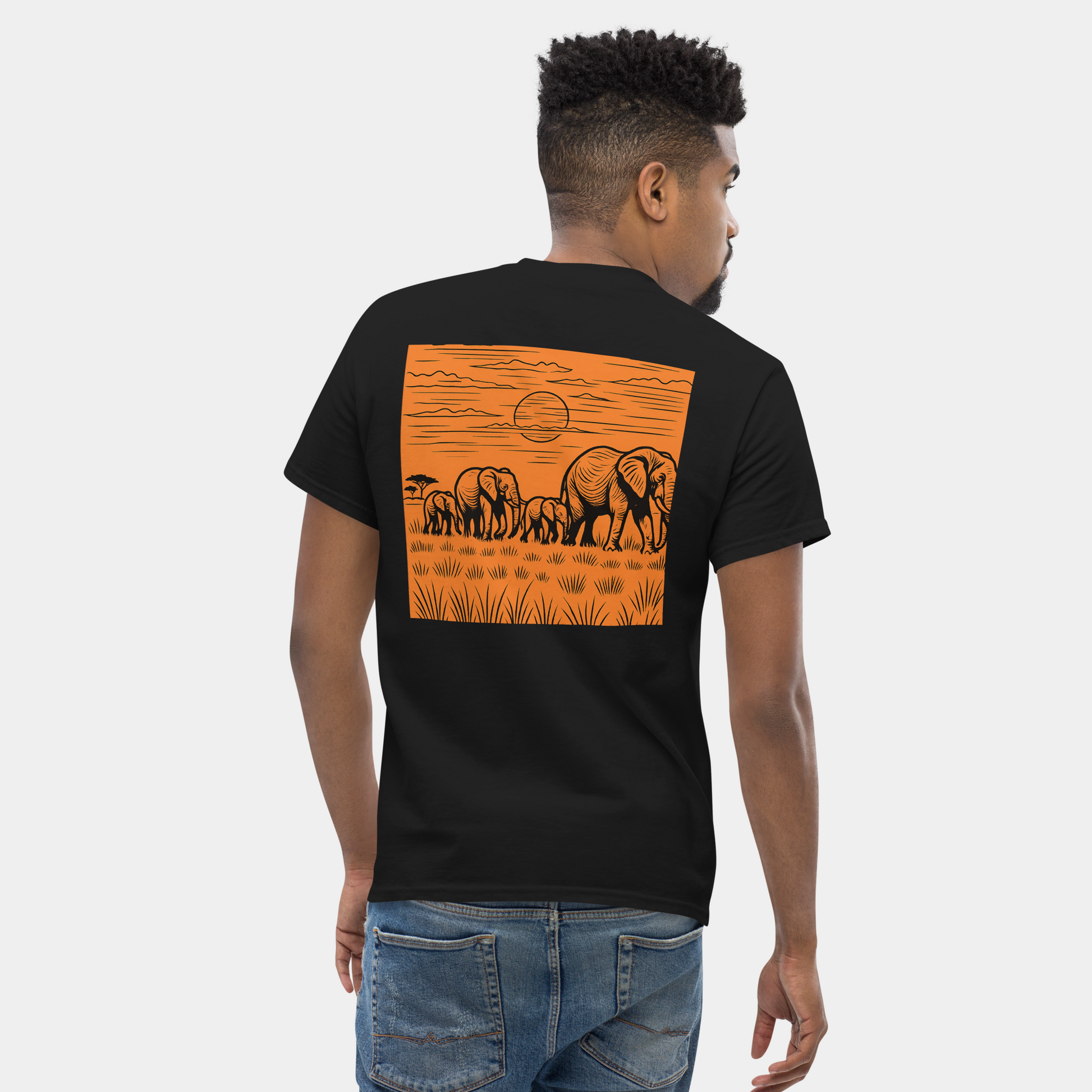 back view of man wearing a black organic cotton creatpix t-shirt with orange elephant sunset graphic – now 15% off